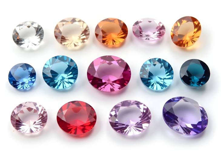 Colorful Round and Oval Gemstones on White Background